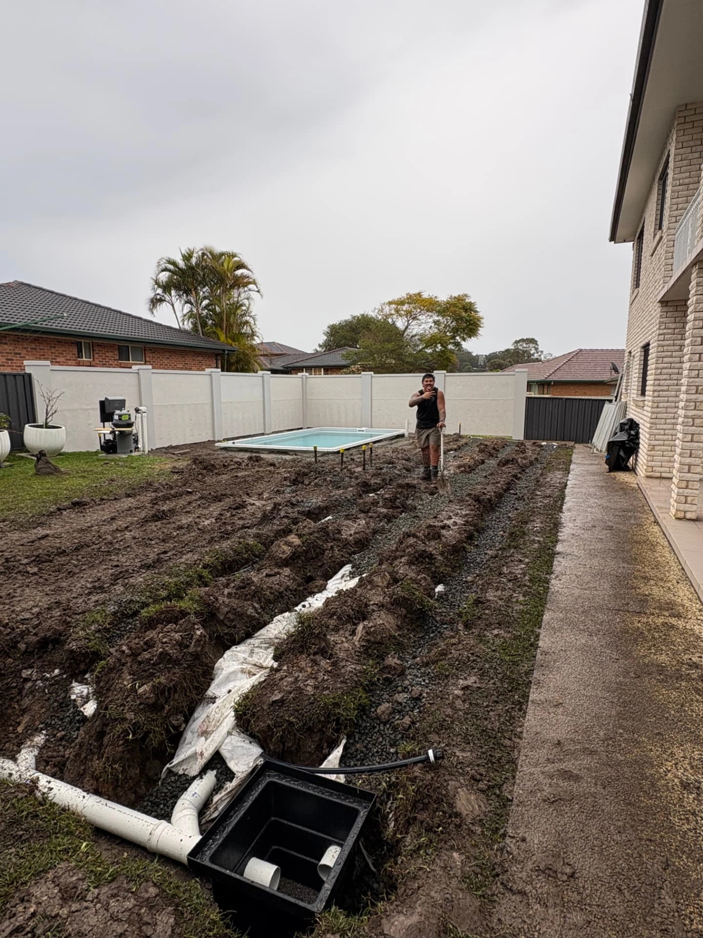 Backyard drainage trenches connected to a stormwater pit