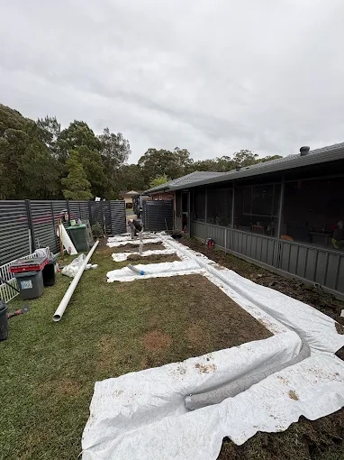 Subsoil drainage grid installed across a backyard
